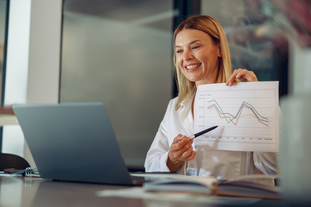 Woman manager showing financial data paper via laptop during online meeting. High quality photo